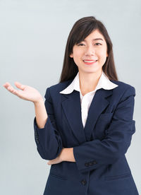 Portrait of a smiling young woman over white background