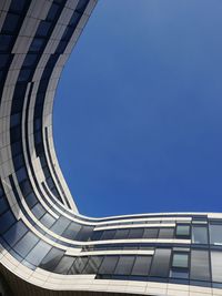 Low angle view of modern building against clear blue sky