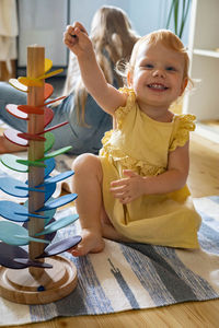 Portrait of smiling girl sitting at home