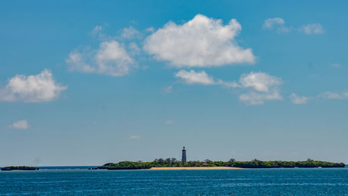 Scenic view of sea by building against sky