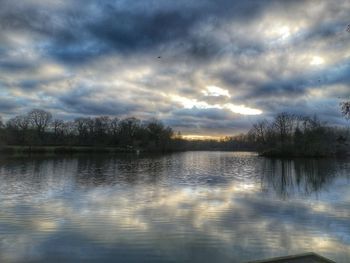 Scenic view of lake against sky at sunset