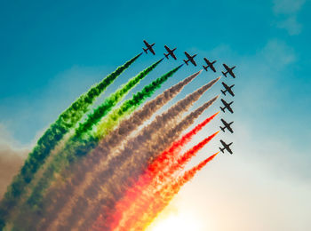 Low angle view of airshow against sky