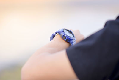 Close-up of hand holding hands against blurred background