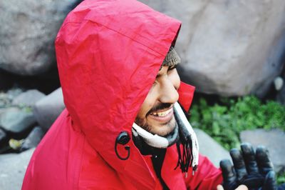 Portrait of smiling man with red umbrella