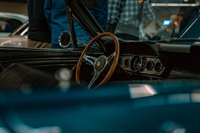 Close-up of person seen through metal grate