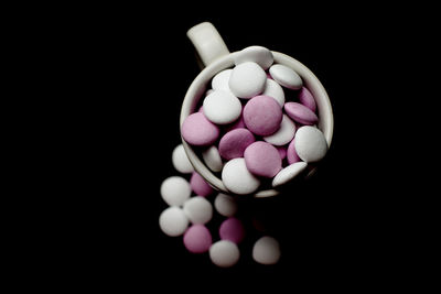 Close-up of pills against black background