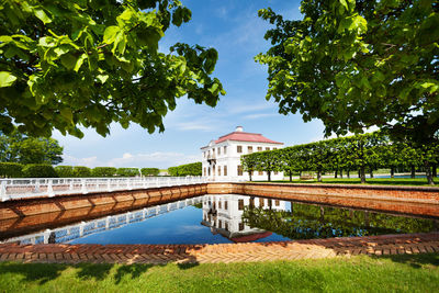 View of swimming pool by lake against sky