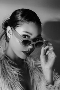 Close-up portrait of young woman wearing sunglasses