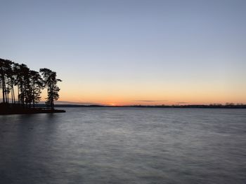 Scenic view of sea against clear sky during sunset