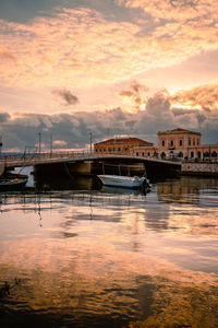 Port of ortigia with boats moored during spectacular sunset