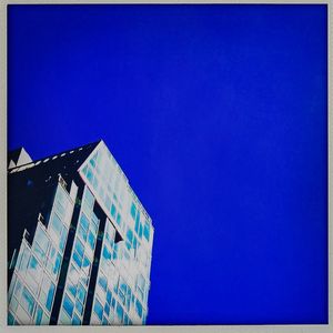 Low angle view of built structure against clear blue sky