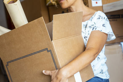 Midsection of woman holding box