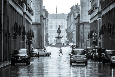 Man running on wet street during monsoon