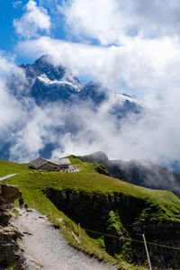 Scenic view of mountains against cloudy sky