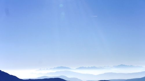 Scenic view of mountains against clear blue sky