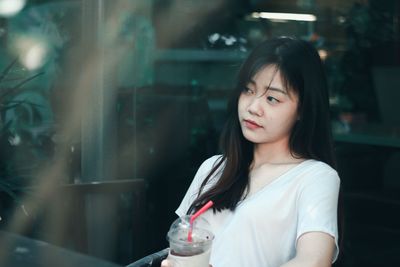 Smiling woman having coffee at cafe