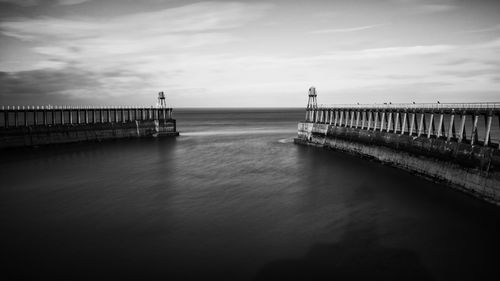 Pier over sea against sky