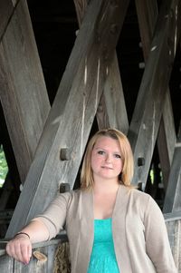 Portrait of young woman standing on bridge