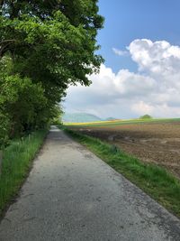 Empty road along countryside landscape