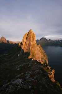 Rock formations by mountain against sky