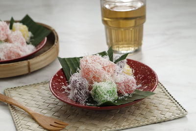 Colorful ongol ongol or sentiling, steamed cassava cake coating with grated coconut