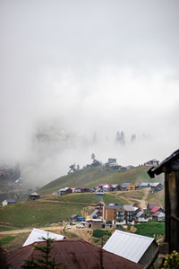 Houses on field against sky