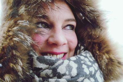 Close-up portrait of smiling young woman with cat