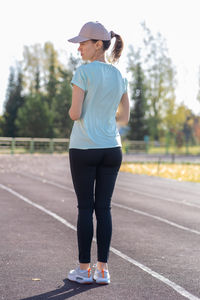 Side view of woman walking on road