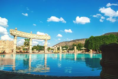 View of swimming pool against cloudy sky