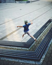 High angle view of boy jumping on staircase