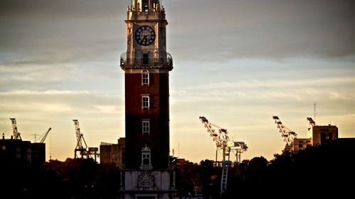 Low angle view of clock tower in city against sky