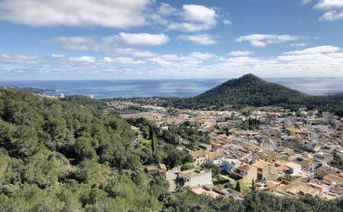 High angle view of townscape by sea against sky