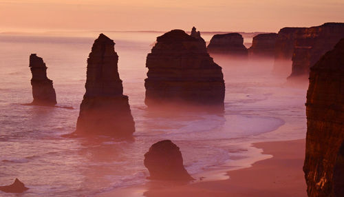 Silhouette of rock formations at seaside