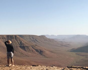 Rear view of man looking at desert
