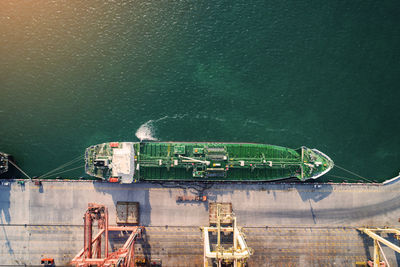 Ship moored in sea against clear sky