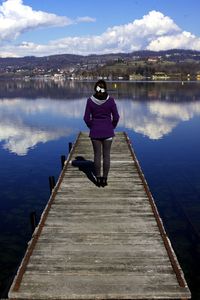 Rear view of woman standing on pier