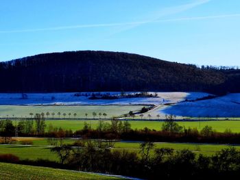 Scenic view of lake against clear blue sky