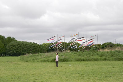Man standing on field against sky