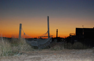 Traditional windmill against clear sky during sunset