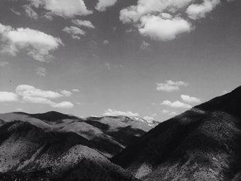 Scenic view of mountains against cloudy sky