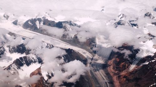 High angle view of snowcapped mountains against sky