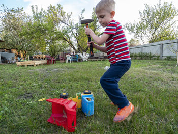 Full length of boy standing on field