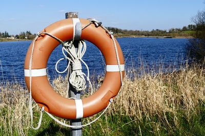 Inflatable ring on pole against river