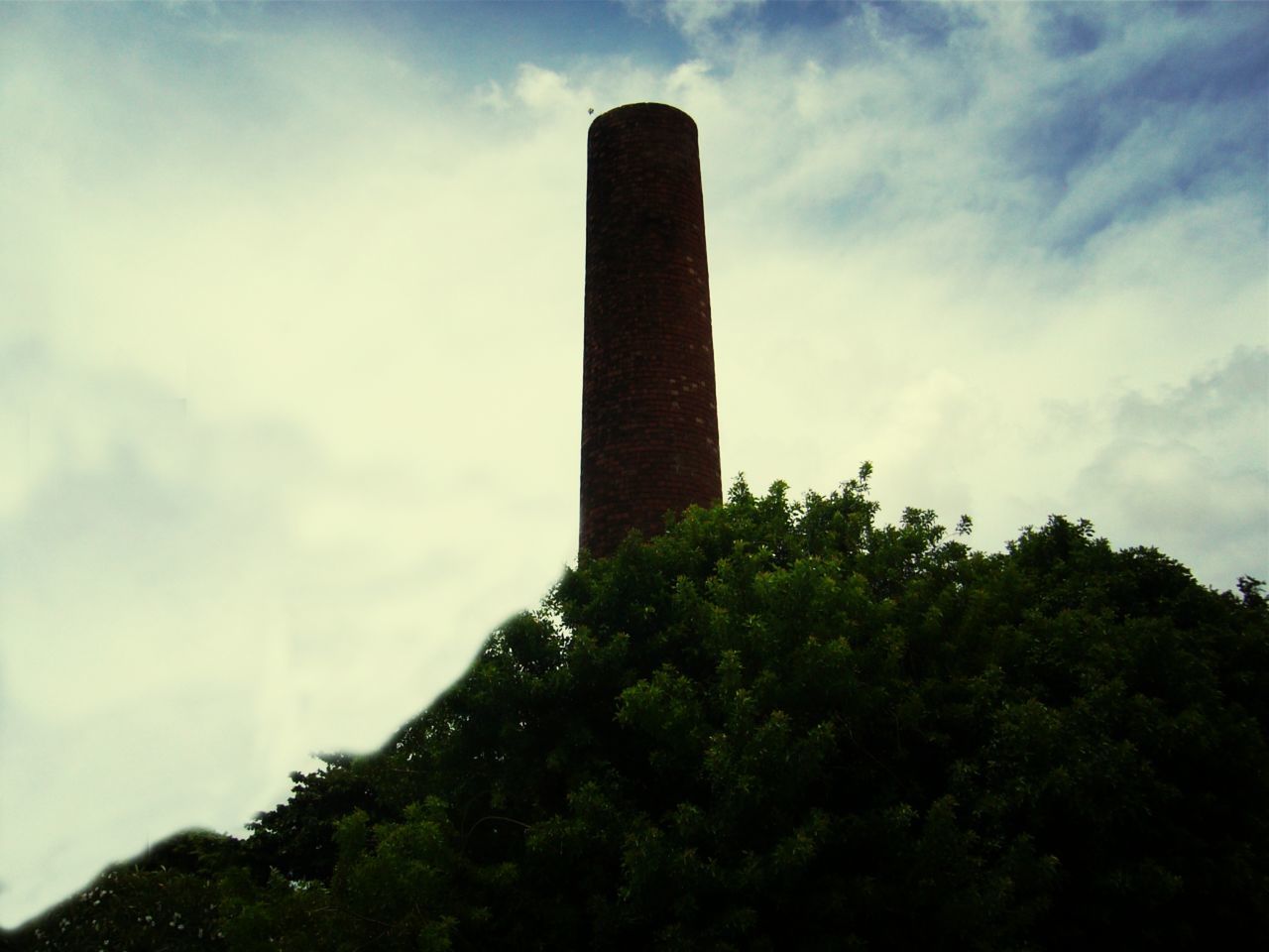 sky, low angle view, architecture, built structure, cloud - sky, building exterior, tall - high, tree, tower, cloudy, cloud, history, famous place, day, no people, outdoors, travel destinations, nature, tall, growth