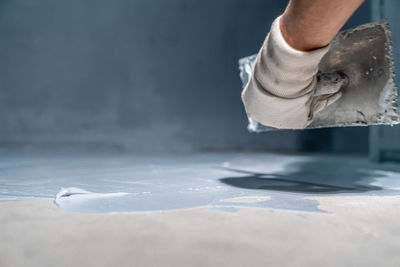 Low section of man standing on snow