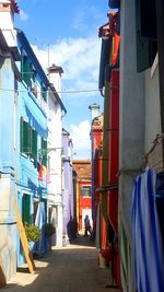 Street amidst buildings in city against sky