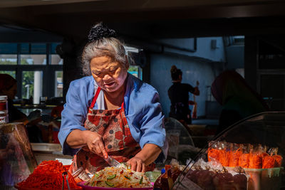 Young woman standing at market stall