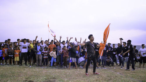 People on field against sky during protest