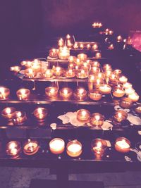 Lit candle in dark room
