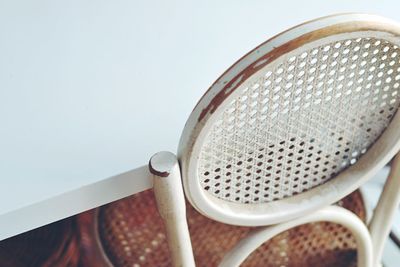 High angle view of a vintage chair and ikea table. old and modern contrast.